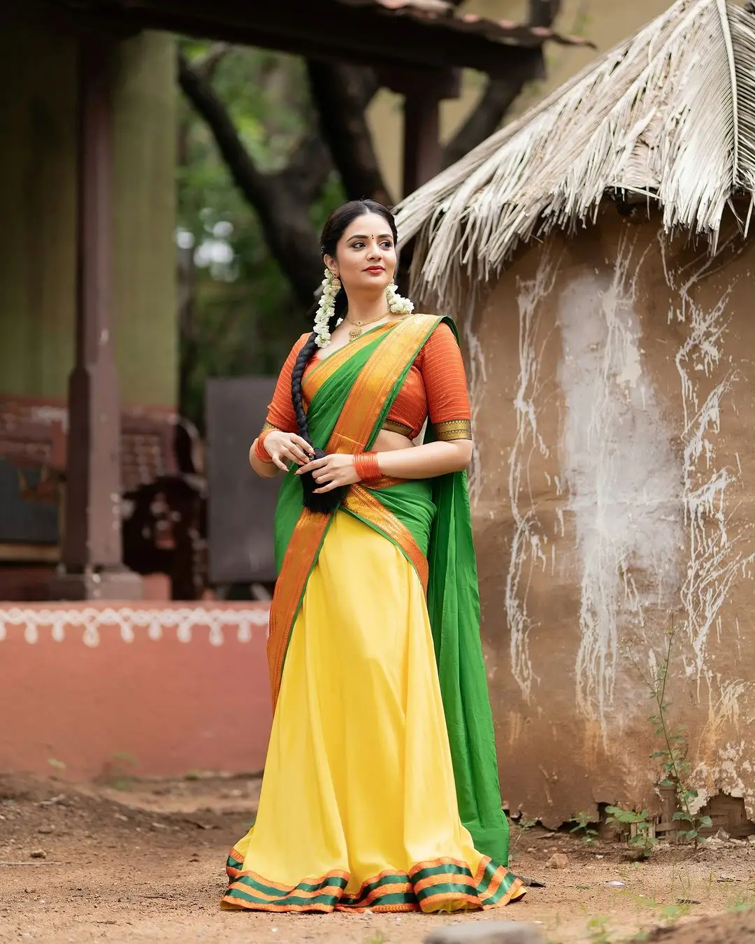 Sreemukhi Stills in Yellow Lehenga Orange Choli Green Voni